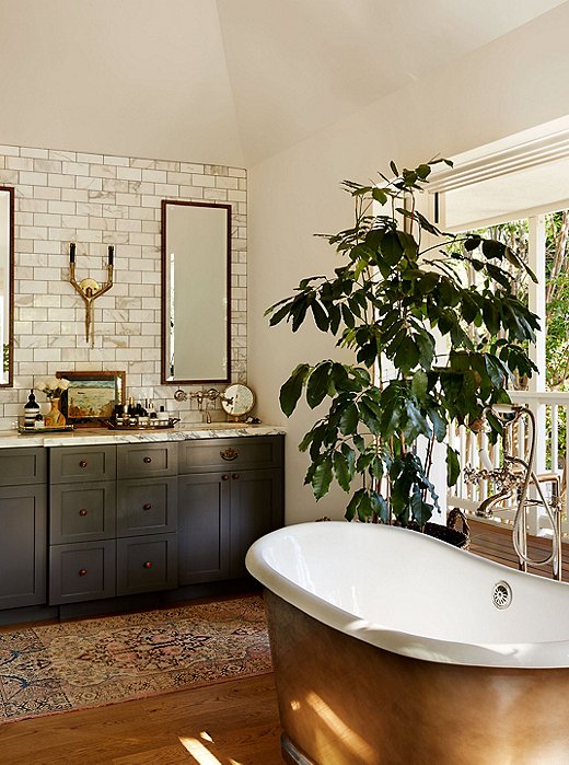 The reds and blues in the runner set off the greens and golds that dominate Emily’s master bathroom.
